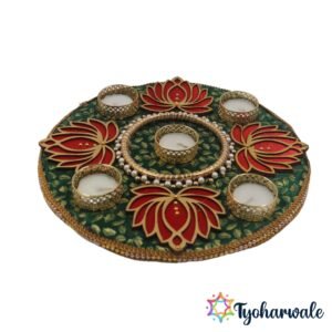 Lotus candle thali on green fabric base with red lotus designs and tea light holders