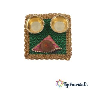 Square haldi kumkum set on green fabric with 2 brass bowls coconut decor and pearl border