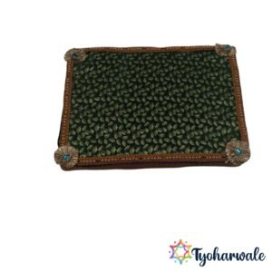 Wooden green ganpati paat chowki with green leaf patterned fabric and decorative borders