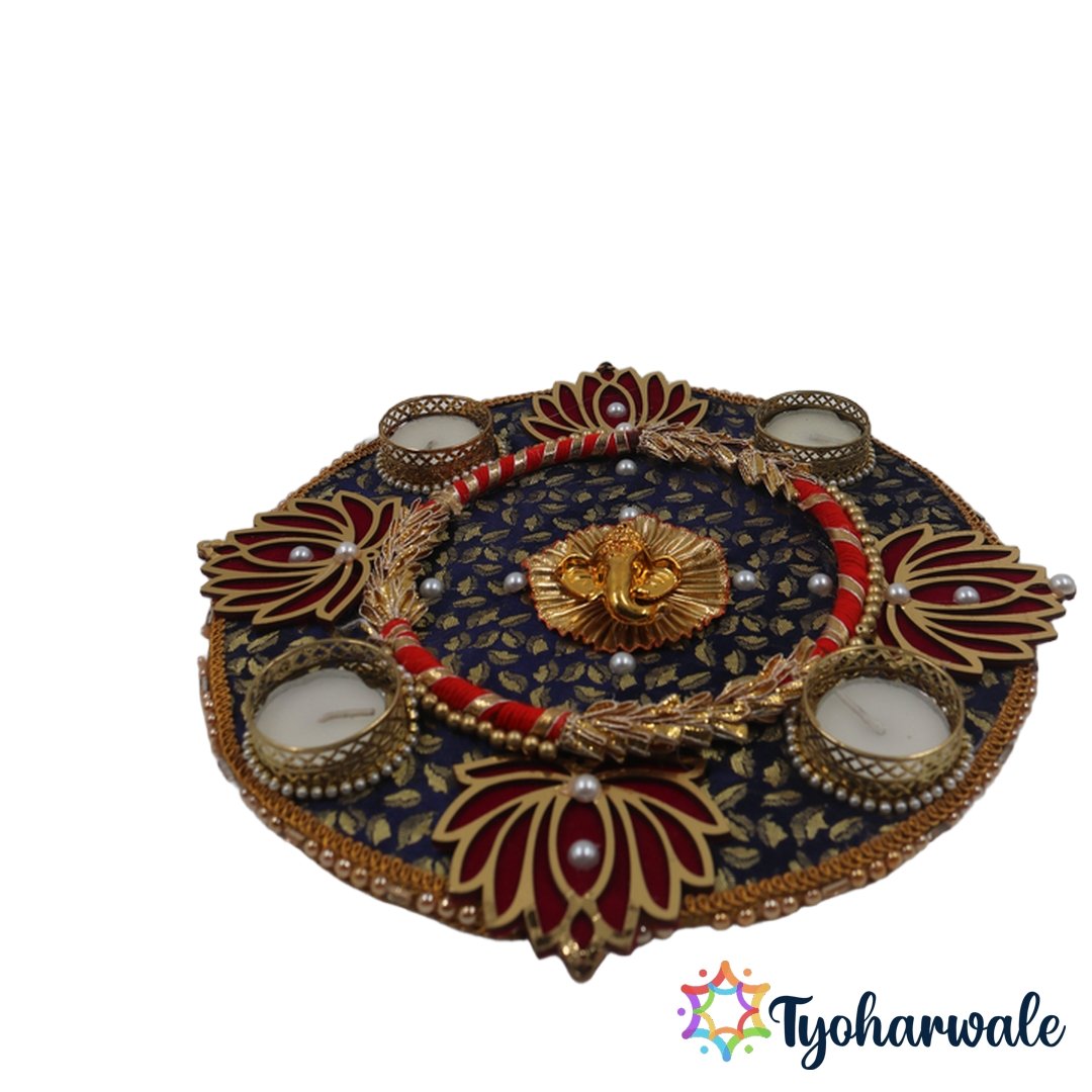 Ganesha candle thali on navy blue fabric base with gold Ganesha idol and 5 tea light holders