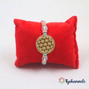 Elegant geometric charm beaded rakhi with gold-tone centre, colourful beads and blue orange twisted thread