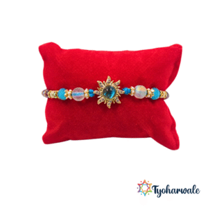 Elegant sunburst blue beaded Rakhi with shimmering centre charm and twisted blue threads