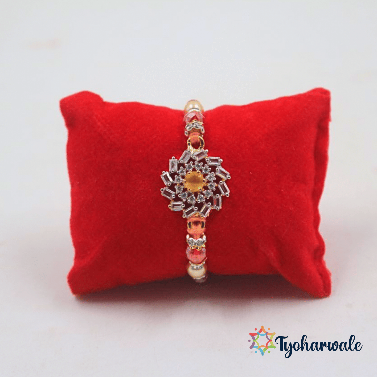 Elegant floral-inspired beaded Rakhi with red and cream beads and decorative centre charm