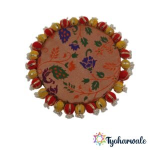 Reversible pooja mat used as a backdrop behind god idols in a home mandir