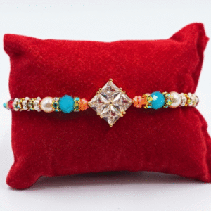 Elegant diamond-shaped charm beaded Rakhi with shimmering stone work, colourful beads and twisted blue and orange thread